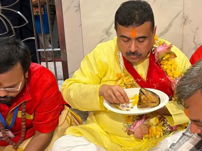 West Bengal CM Suvendu Adhikari ate Mach Bhog at Kalighat temple.