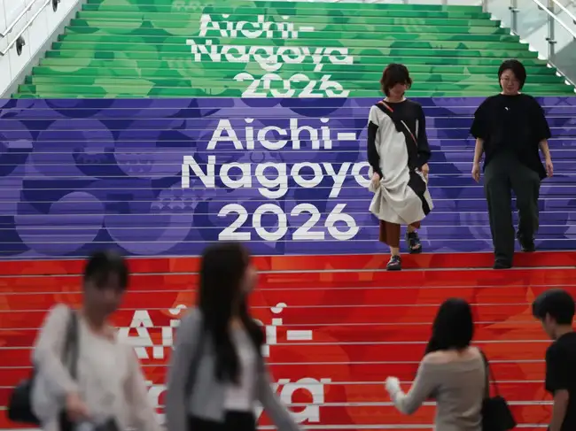 People walk past Asian Games signages in Nagoya