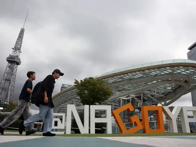 People walk past the Chubu Electric Power Mirai Tower in Nagoya