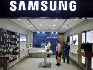 FILE PHOTO: Customers shop at a Samsung mobile store inside a shopping mall in New Delhi