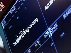 A screen shows the logo and a ticker symbol for The Walt Disney Company on the floor of the New York Stock Exchange (NYSE) in New York, U.S., March 21, 2025.