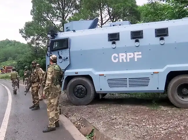 Rajouri, Aug 21: CRPF personnel stand guard along Rajouri-Poonch highway t...