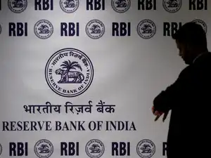 FILE PHOTO: A man stands in front of the Reserve Bank of India (RBI) logo inside its headquarters in Mumbai, India, February 6, 2026.