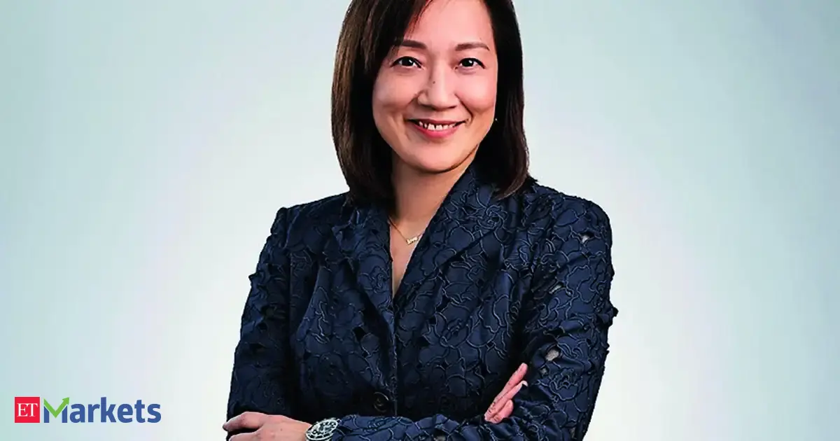 Judy Hsu, CEO of Standard Chartered, next to a financial chart, emphasizing long-term equity investment.