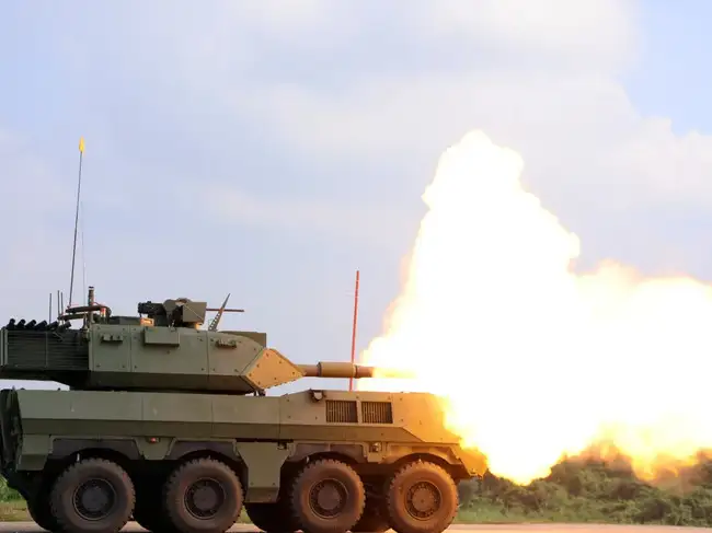 Wheeled armoured vehicle fires during a live-fire demonstration in Tainan