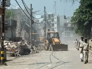 New Delhi, Sep 21: Local authorities carry out demolition work against ill...