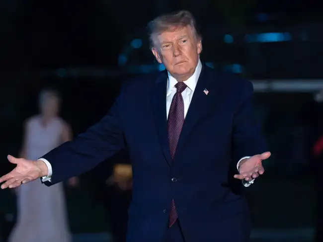 President Donald Trump gestures to reporters<br>