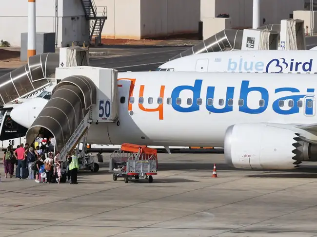 Travelers board a FlyDubai aircraft at Ben Gurion International Airport after a separate FlyDubai flight from the United Arab Emirates to Israel was diverted to Saudi Arabia following an emergency