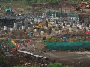 Workers and excavators operate at the site of an Amazon data centre in Thane, India, September 22, 2026.