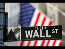 FILE PHOTO: A street sign for Wall Street is seen outside the New York Stock Exchange (NYSE) in New York City, New York, U.S., July 19, 2021.