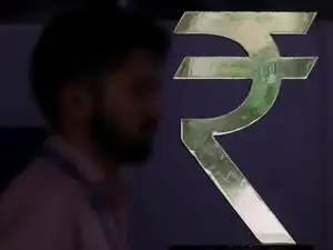 A man walks past a Rupee installation at the Reserve Bank Of India (RBI) headquarters in Mumbai, India, April 8, 2026.