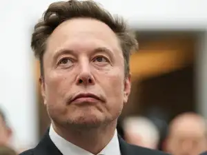 FILE - Elon Musk listens as President Donald Trump speaks during an event at the U.S. Institute of Peace, Oct. 8, 2026, in Washington.