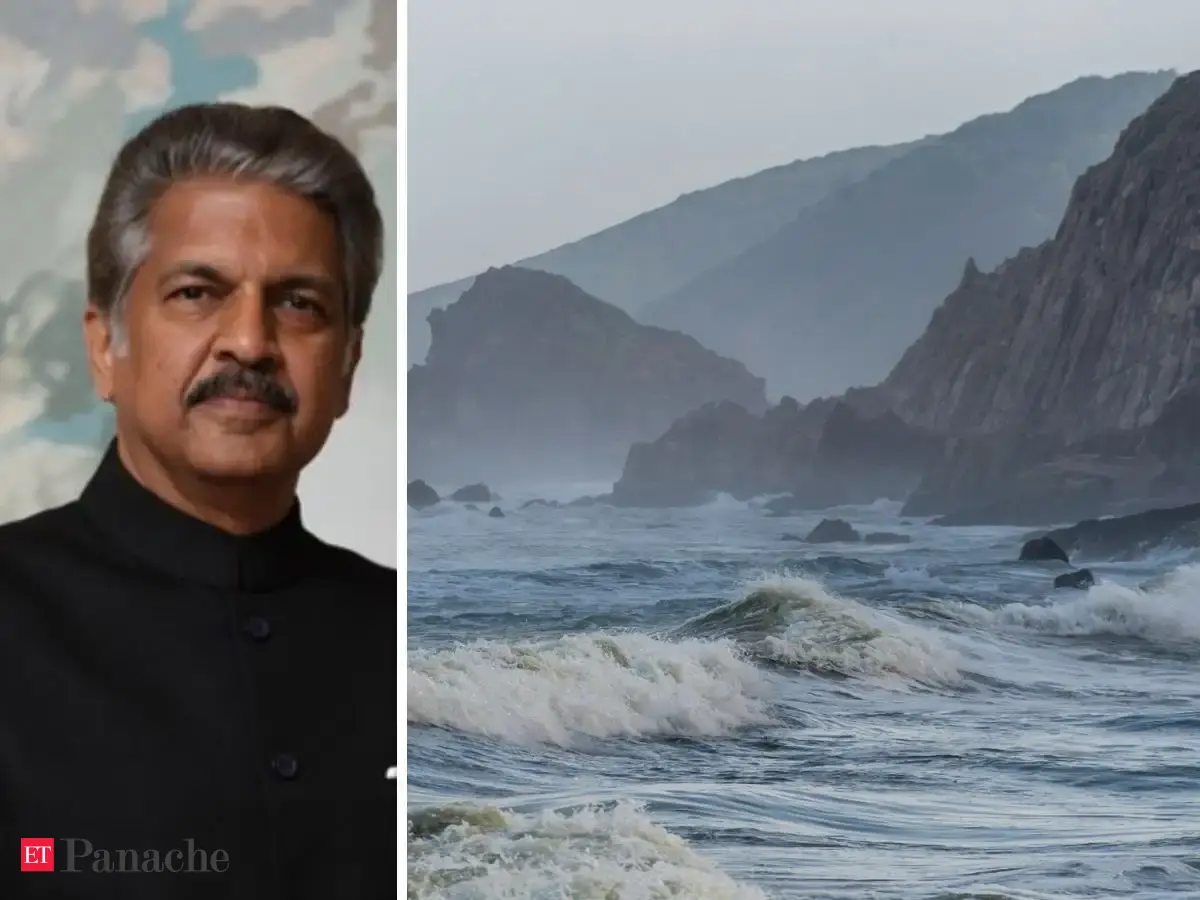 Towering rocky cliffs overlooking the ocean at Gangavaram Beach, Visakhapatnam, India, with no coconut palms visible.