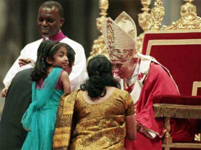 Pope Benedict XVI blesses a family during the holy mass
