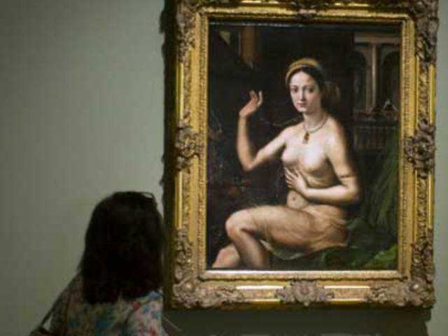The painting entitled 'Woman at a Mirror' by Rafael 