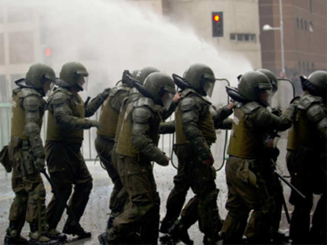 Riot police charge on opponents of late Chilean dictator general Augusto Pinochet