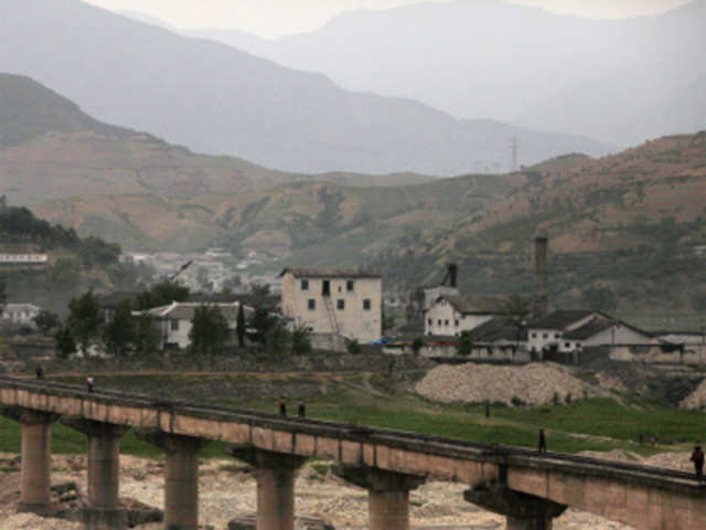 North Koreans cross a bridge outside of Pyongyang, North Korea