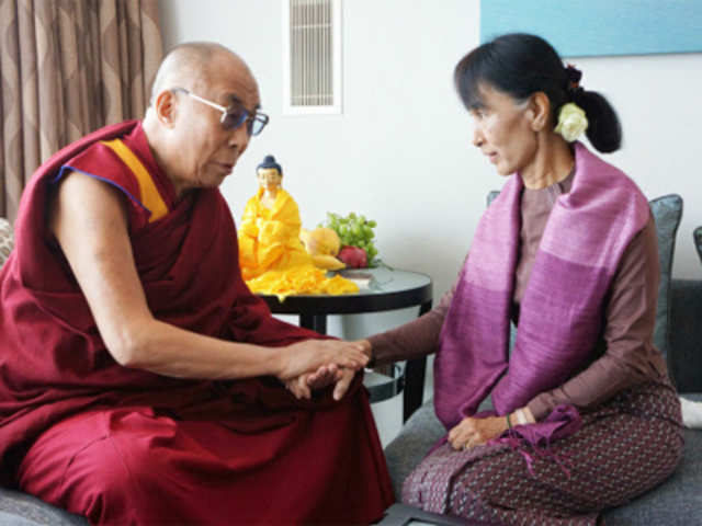 Tibetan spiritual leader the Dalai Lama, speaks to Aung San Suu Kyi