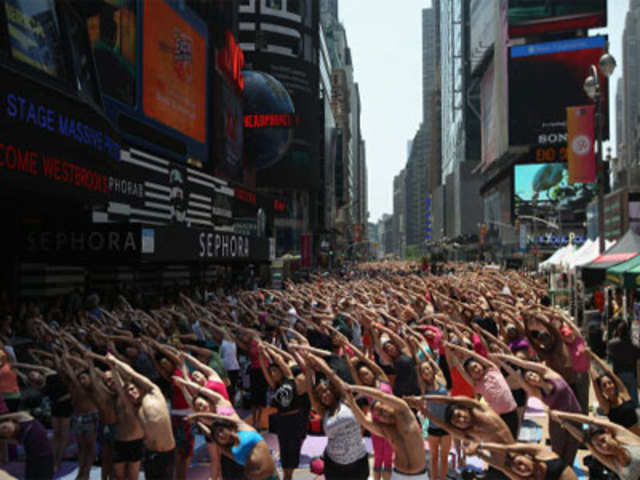 People practicing bikram yoga in Times Square