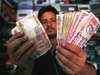 Rupee hits record low of 57 against dollar