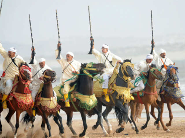 Moroccan horsemen perform on the occasion of the Gnaoua World Music Festival