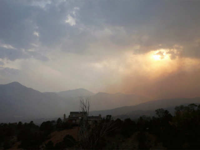 The setting sun is obscured by smoke from the Waldo Canyon fire west of Colorado Springs