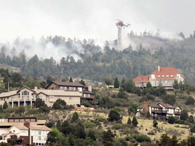 A helicopter battles a wildfire near Colorado Springs, Colorado