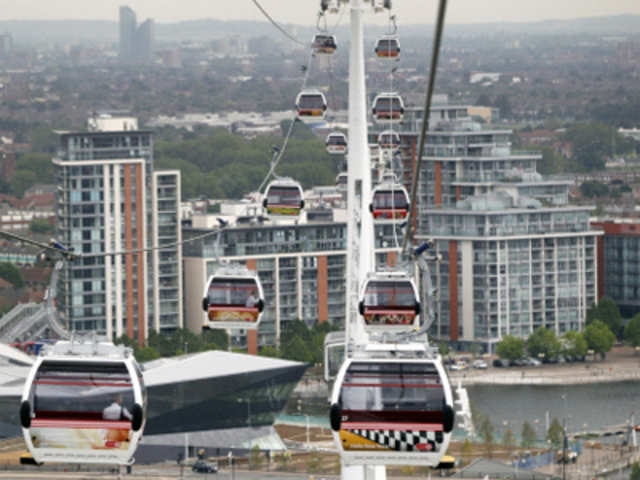Transport for London's gondola lift cable cars are seen across the River Thames