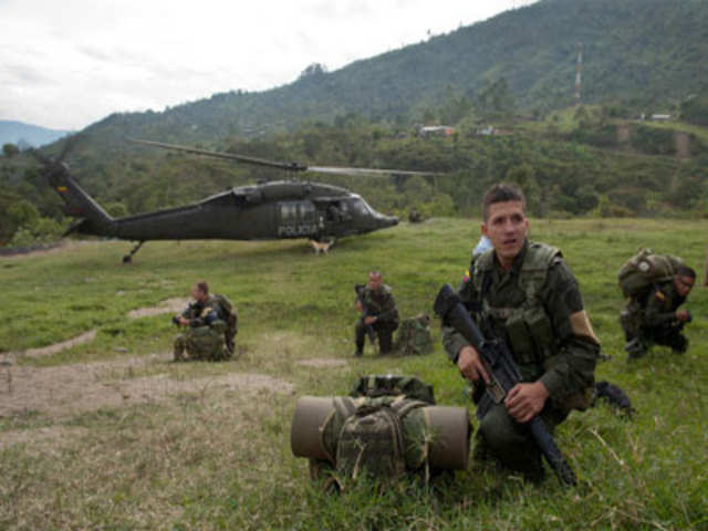 Colombian policemen secure a landing zone