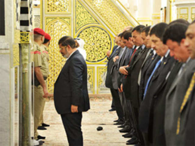 Egypt's President Mohamed Mursi prays at Al-Rawadeh