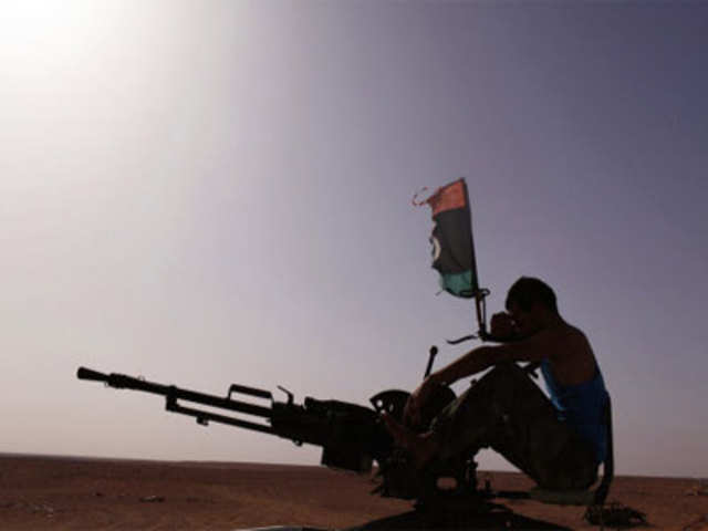 A rebel from Misrata test fires a machine gun