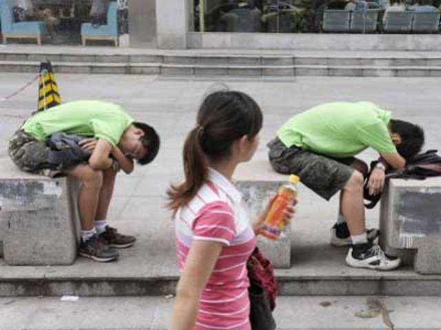 Two young men asleep on cement blocks in China