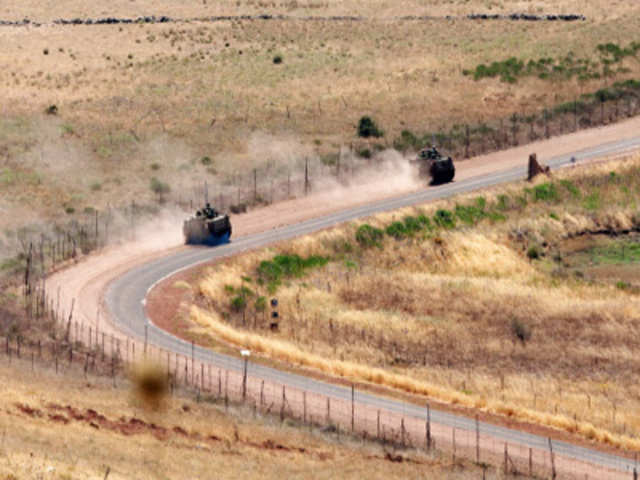 Israeli army vehicles along the Israel-Syria border