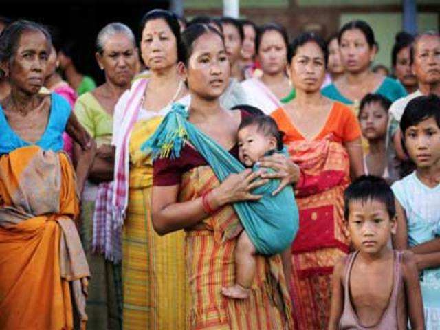A Bodo woman holds her baby at a relief camp