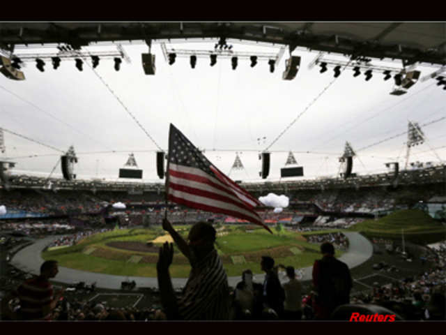 Rome Milan waves the American flag before the opening ceremony