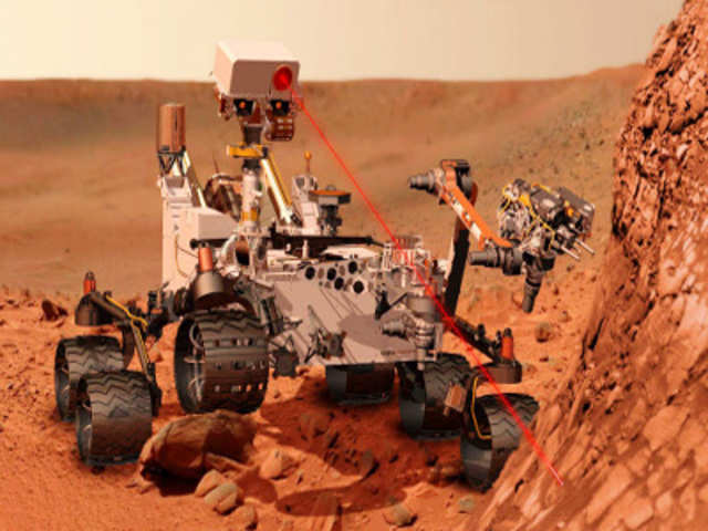 Artist's concept depicting mars rover Curiosity, investigating the composition of a rock surface