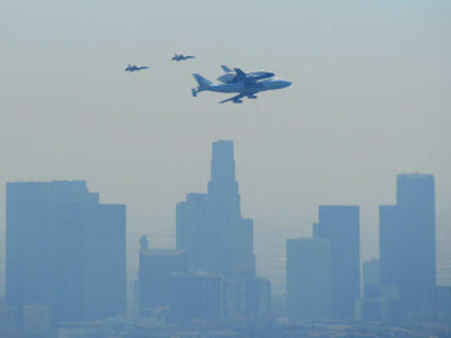 The Space Shuttle Endeavour, mounted atop NASA's modified Boeing 747, flies over downtown in Los Angeles