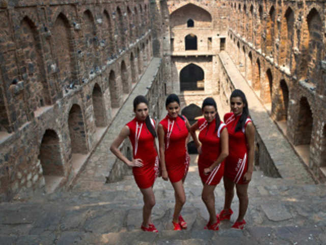 Indian Formula One grid girls pose during a promotional event at the Agrasen ki Baoli in New Delhi