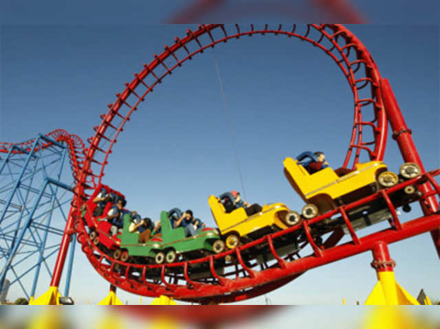 Palestinians ride a roller coaster at an amusement park in Gaza City