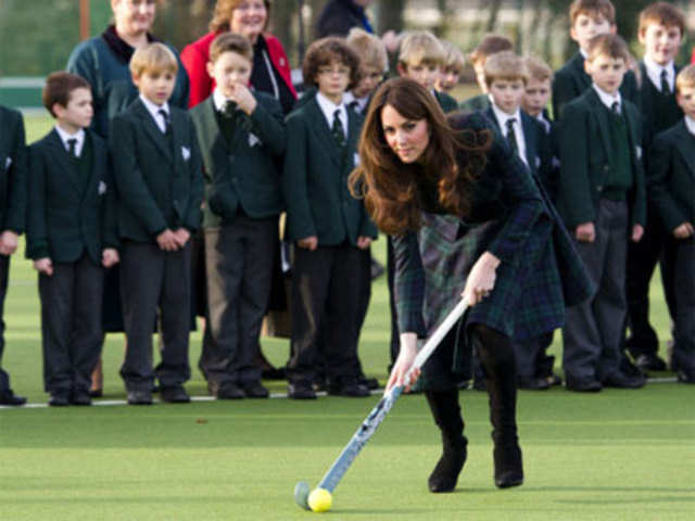 Britain's Catherine, Duchess of Cambridge, plays hockey with students