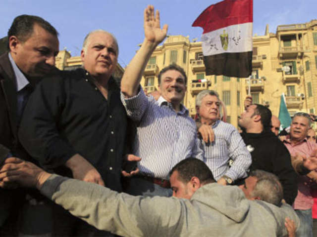 Egypt's Liberal Wafd party chairman Al-Sayed al-Badawi greets people in Cairo