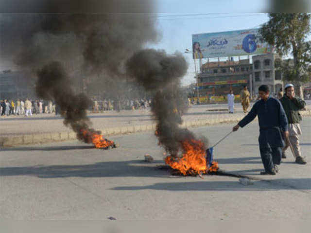 Pakistani Islamists burn tyres during a protest in Islamabad
