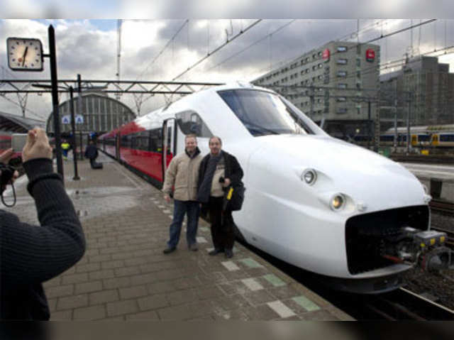 People posein front of new high speed train Fyra