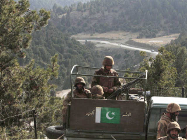 Pakistan army soldiers sit in a vehicle during their patrol at an army outpost