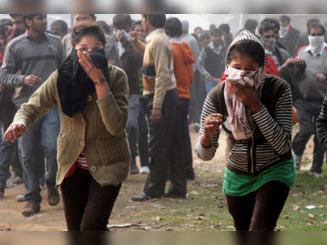 Demonstrators cover their face due to tear gas during protest 