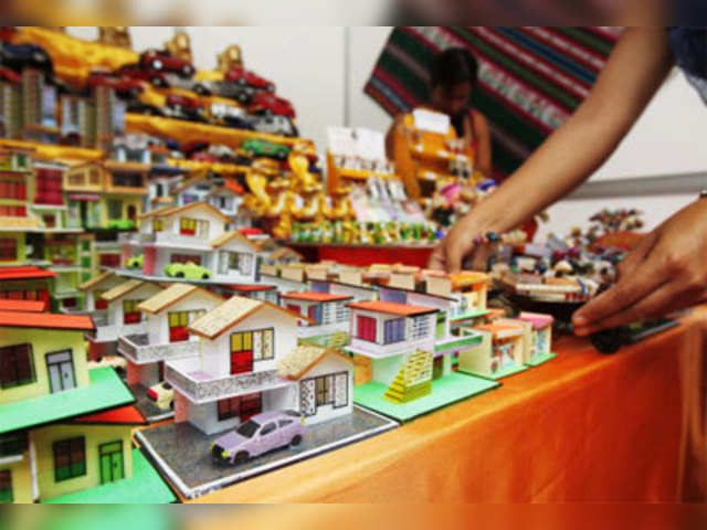 A seller displays miniature houses sold as lucky charms