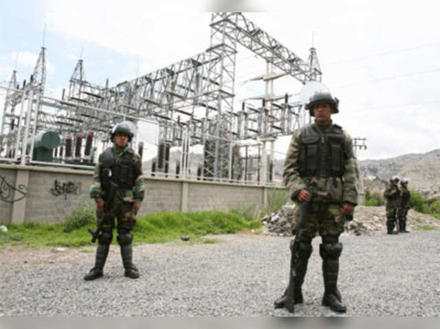 Bolivian police officers stand guard in front of Electropaz Plant