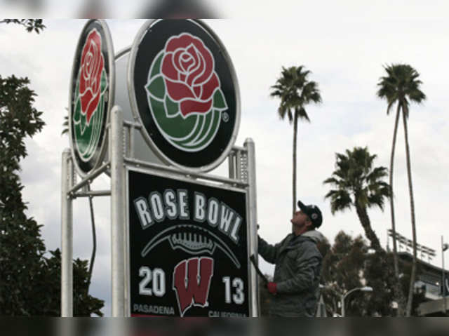 A worker adjusts a sign outside the Rose Bowl in Pasadena
