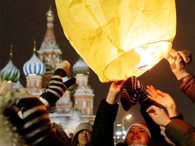 Revellers launch a floating paper lantern in Moscow