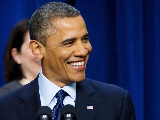 Obama smiles as he speaks about fiscal cliff